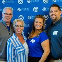 Four alumni pose for a photo at the Laker Legacy Brunch